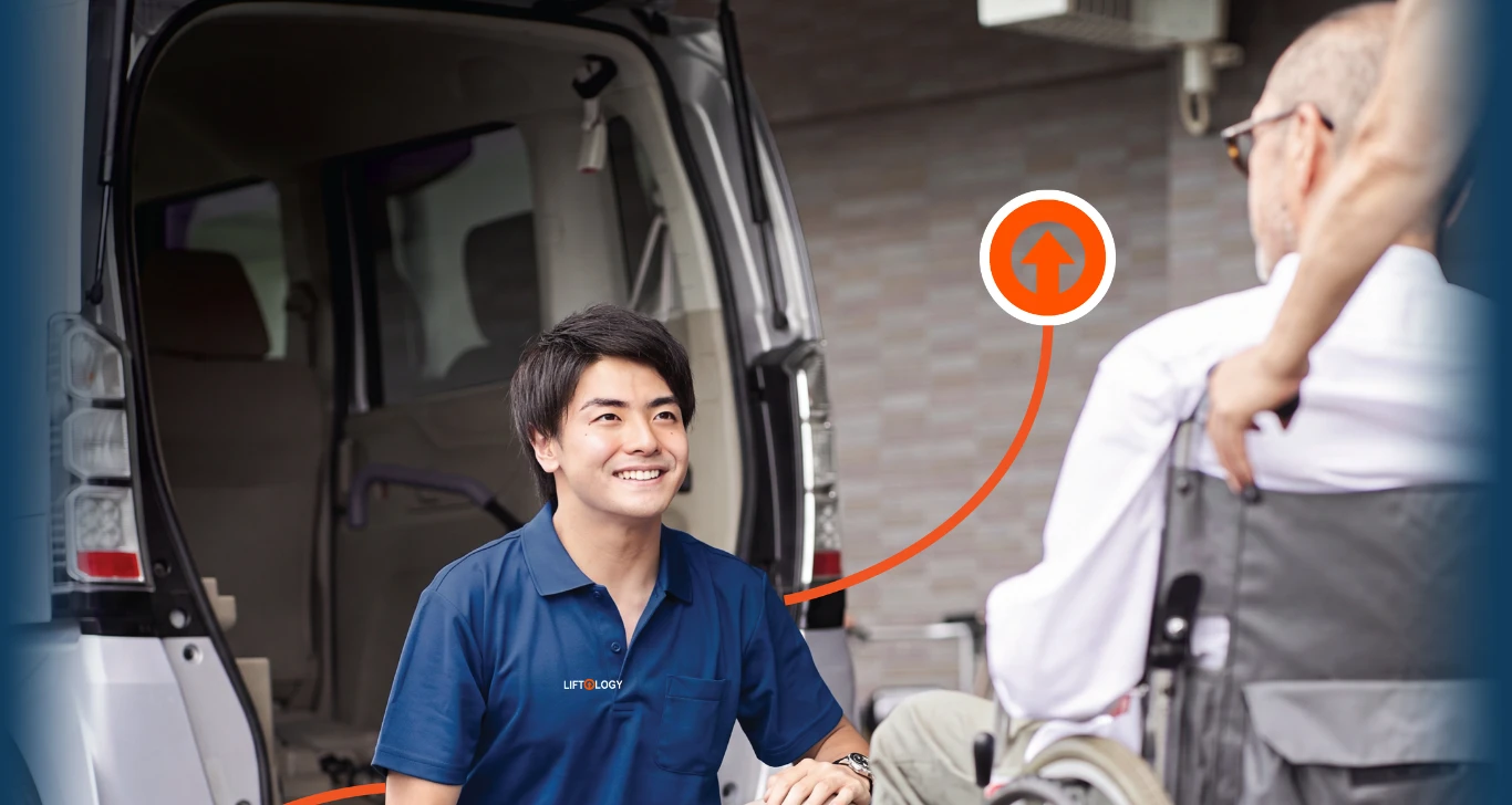 A Liftology specialist helping a customer beside an accessible vehicle